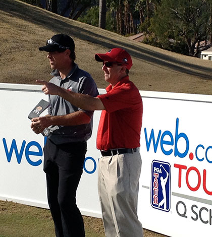 NIU Coach Tom Porten assesses options with Jake Scott during practice round