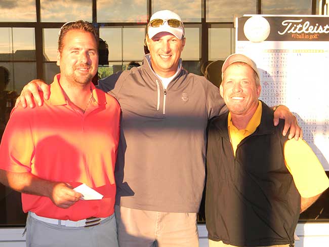 Tournament Director Ty Kovach (center) congratulates first year champions Brian Smith (l) and Randy Crider (r).