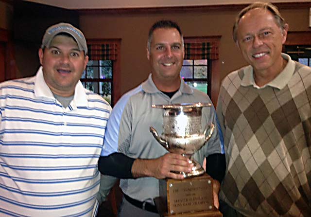 Steve Blackburn Jr. holds the Thompson Cup as the 2014 champion, flanked by Dave Sotka and John Niedzialek