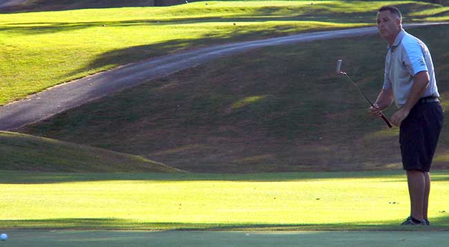 Blackburn putts from the front of the par-3 green on the fourth playoff hole, and his ball rattles around the flag but won't stay in.