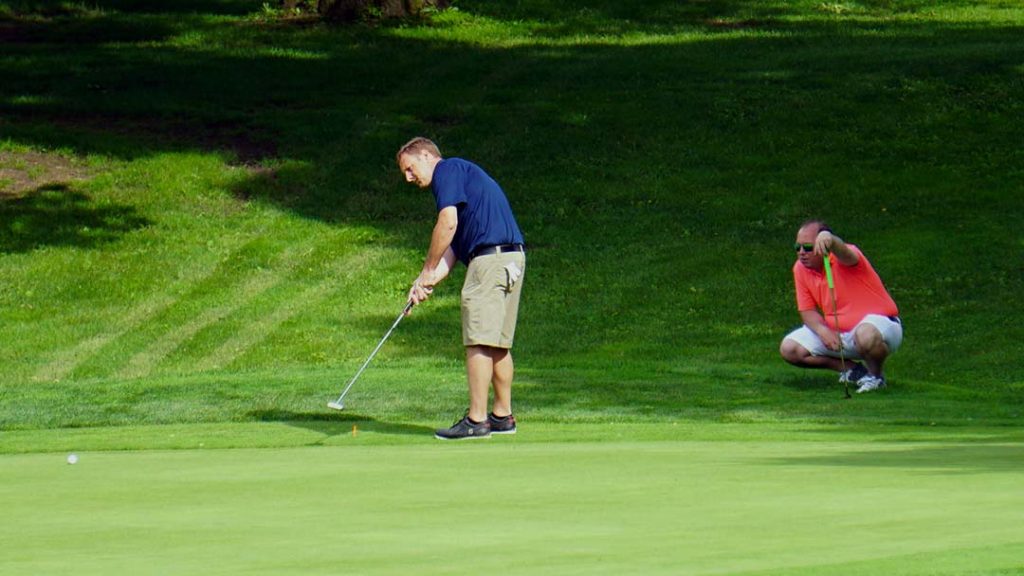 Dave Oates rolls a putt at the second as partner Vaughn Snyder watches in the 2019 Ungvary Memorial at Good Park.