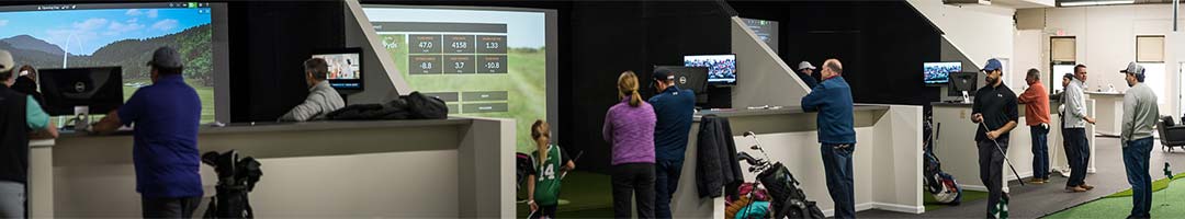 Players using the TrackMan simulator bays at The Clubhouse Cleveland