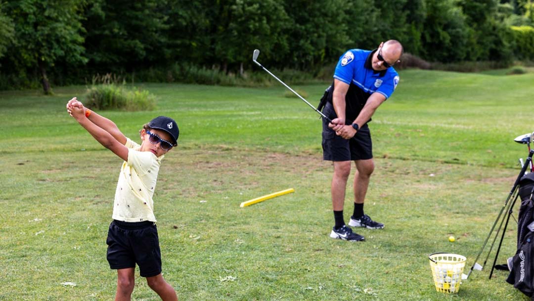 Practice makes perfect for a Copley Police officer and a Putting with Police participant. 