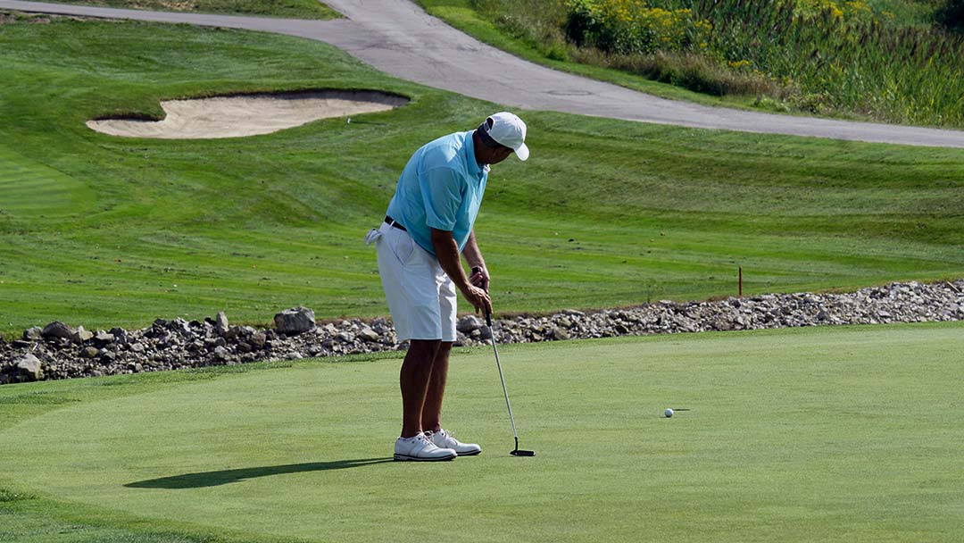 Mark Guadagni rolls his first putt at the 18th to tap-in range to secure a victory.